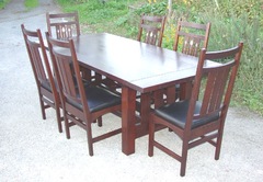 Shown without leaves surrounded by six inlaid dining chairs.